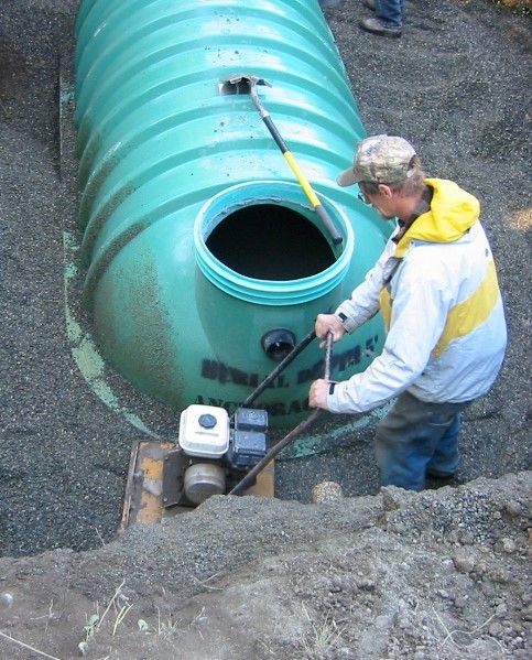 Compacting fill around a septic tank 